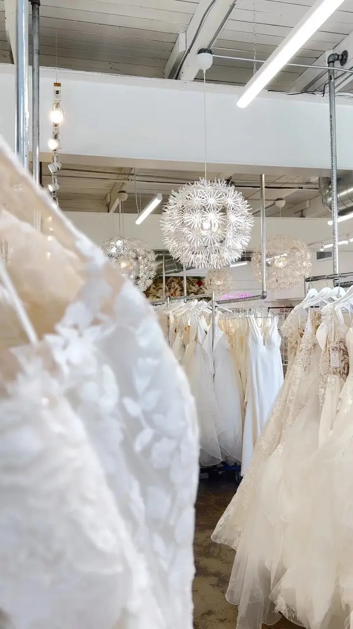 Inside Liliana Bridal House bridal shop. Rack of wedding dresses.